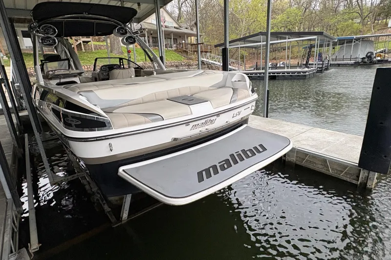 Slide: The Image of 2011 Malibu Wakesetter 247 LSV docked at a lakeside marina. - 7