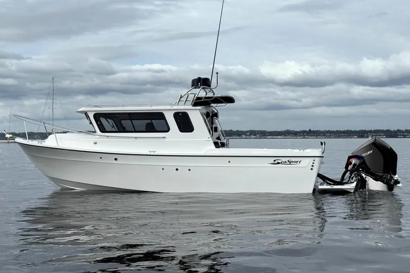 The Image of SeaSport Kodiak 2600 boat on calm water under cloudy sky. - 1