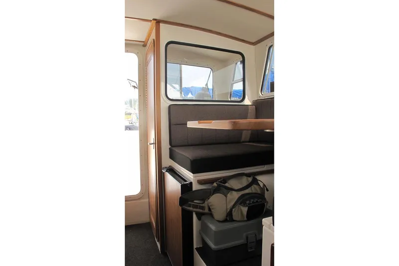 Slide: The Image of Interior of SeaSport Kodiak 2600 boat with seating and storage area. - 6