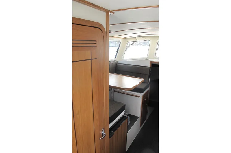 Slide: The Image of Interior of SeaSport Kodiak 2600 boat with wooden cabinetry and seating area. - 7