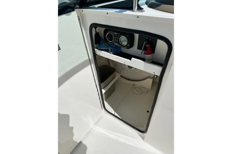 Slide: The Image of Interior view of a 2012 Sea Ray 220 Sundeck boat cabin with storage space. - 12