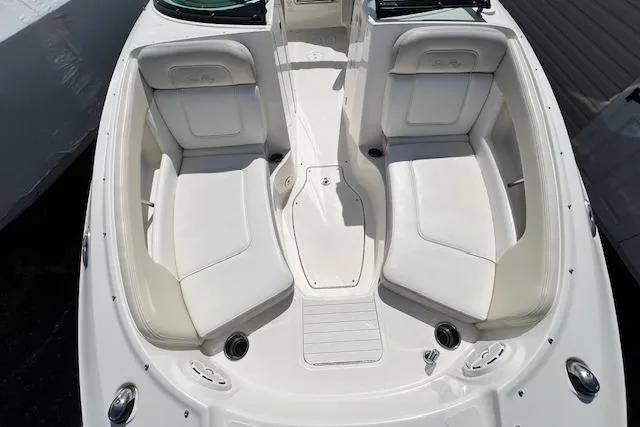 Slide: The Image of 2012 Sea Ray 220 Sundeck boat interior with white seating and sleek design. - 13