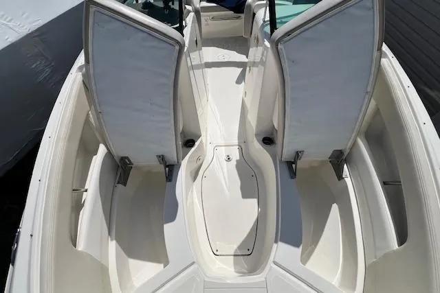 Slide: The Image of 2012 Sea Ray 220 Sundeck boat interior with open storage compartments. - 15