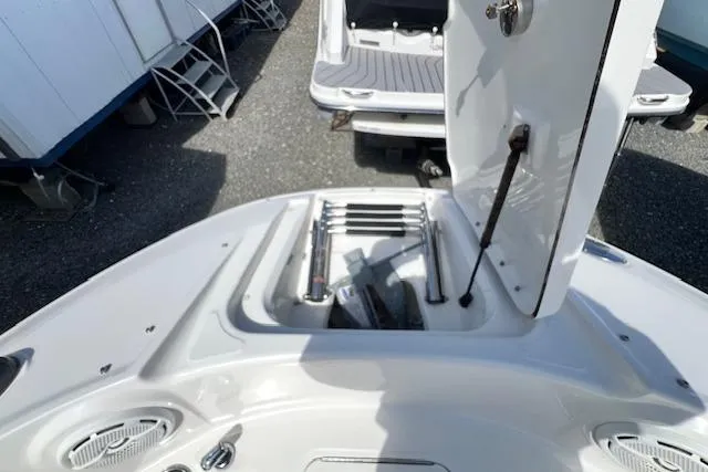 Slide: The Image of 2012 Sea Ray 220 Sundeck boat with open storage compartment and ladder. - 16