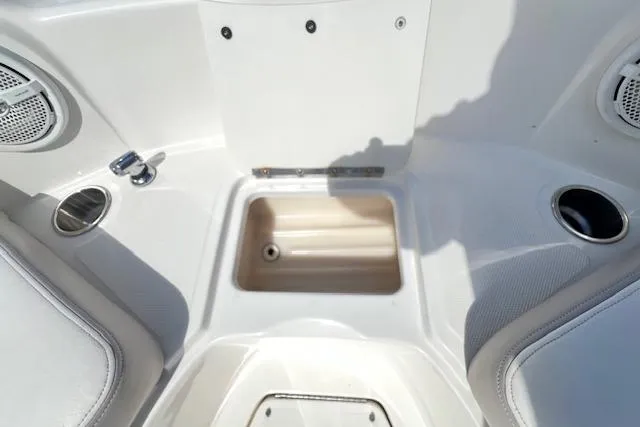 Slide: The Image of Interior view of a 2012 Sea Ray 220 Sundeck boat, featuring seating and cup holders. - 17