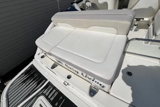 Slide: The Image of 2012 Sea Ray 220 Sundeck boat with white seating and "Get Busy Living" text. - 18