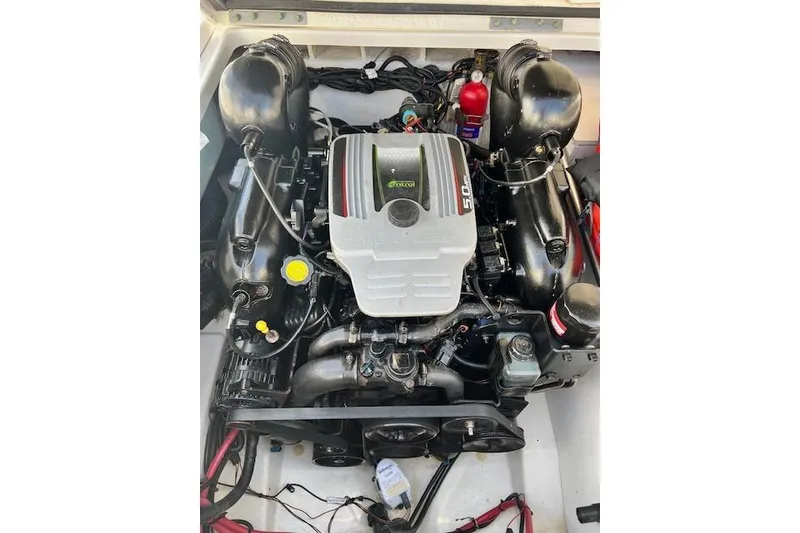 Slide: The Image of Engine compartment of a 2012 Sea Ray 220 Sundeck boat, showcasing detailed components. - 20