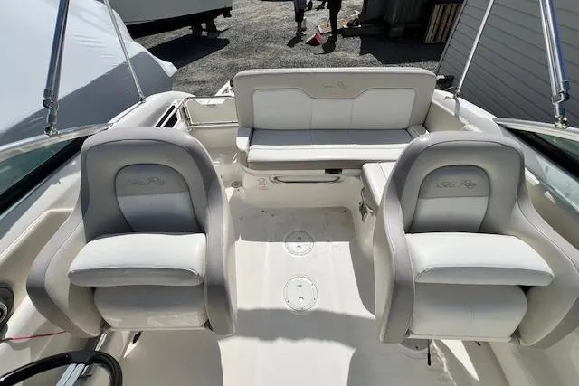Slide: The Image of 2012 Sea Ray 220 Sundeck boat interior with white seating and helm chairs. - 7