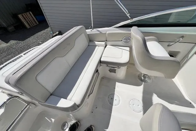 Slide: The Image of 2012 Sea Ray 220 Sundeck interior with white seating and modern design. - 8