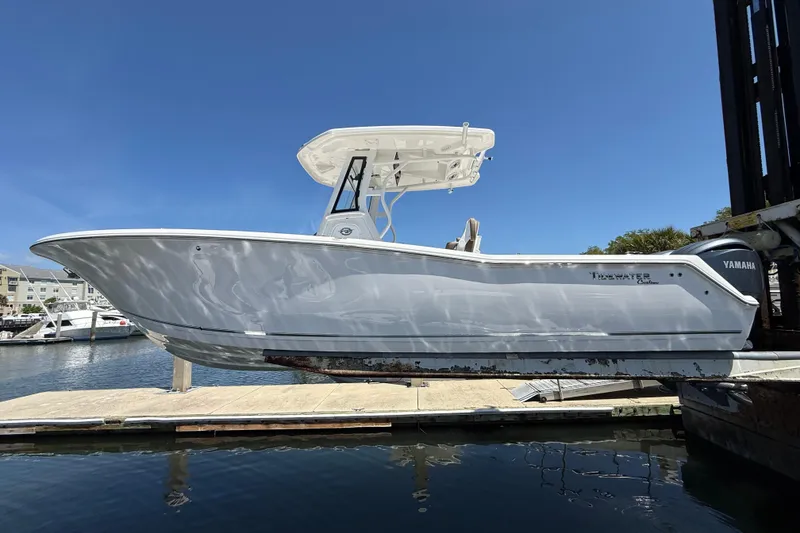 The Image of 2025 Tidewater 272 CC Adventure boat on lift, dockside view. - 0