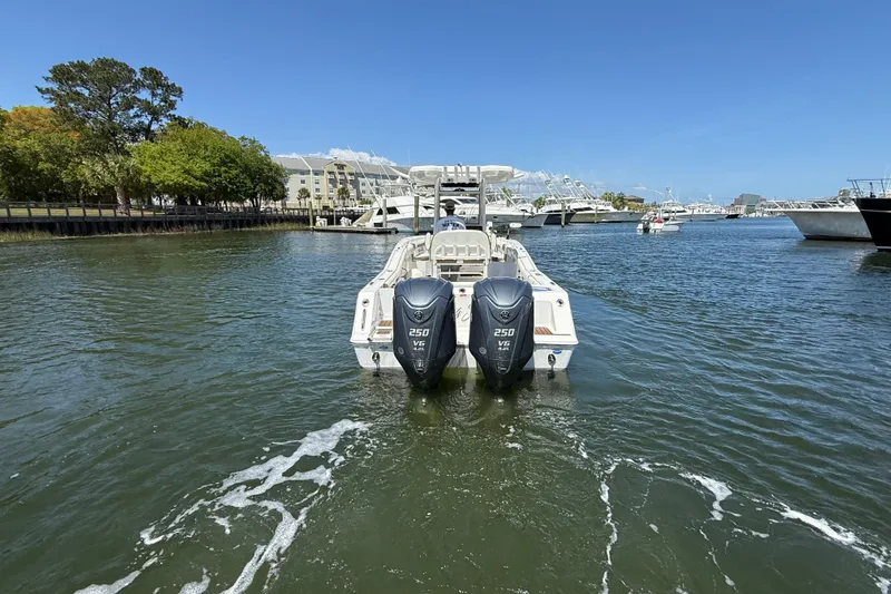 Slide: The Image of 2025 Tidewater 272 CC Adventure boat with dual 250 V6 engines on a sunny day. - 10