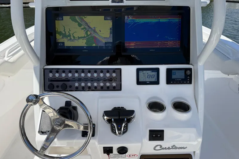 Slide: The Image of 2025 Tidewater 272 CC Adventure boat dashboard with navigation screens and controls. - 11