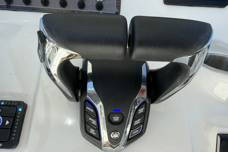Slide: The Image of Throttle controls on 2025 Tidewater 272 CC Adventure boat dashboard. - 16