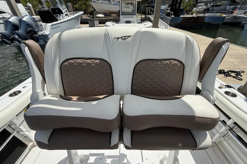 Slide: The Image of 2025 Tidewater 272 CC Adventure boat seats with brown and white upholstery. - 19