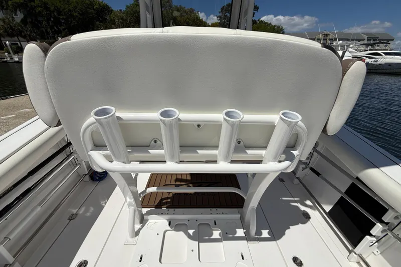Slide: The Image of 2025 Tidewater 272 CC Adventure boat with rod holders and cushioned seating. - 20