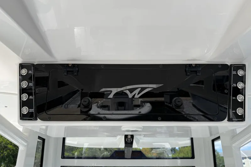 Slide: The Image of 2025 Tidewater 272 CC Adventure boat dashboard with control panel and logo. - 24
