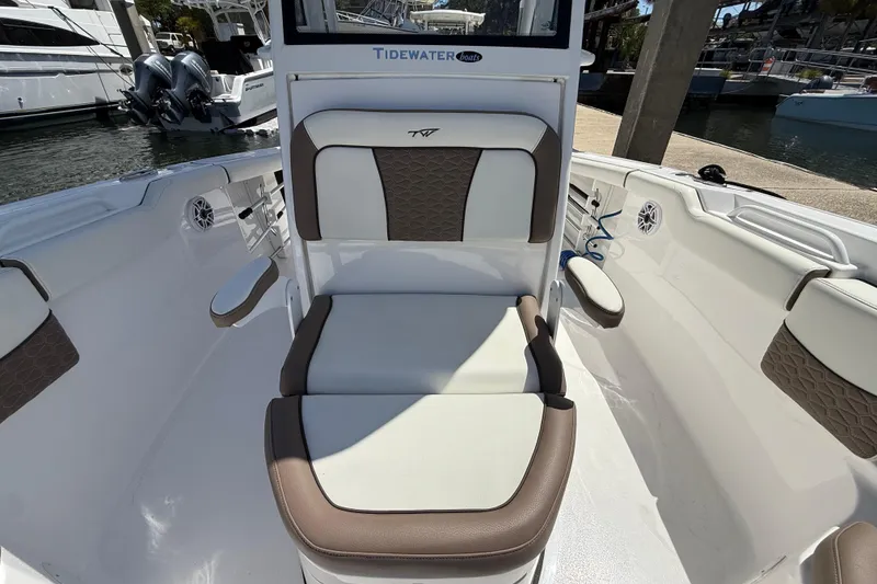 Slide: The Image of 2025 Tidewater 272 CC Adventure boat interior with cushioned seating and modern design. - 25