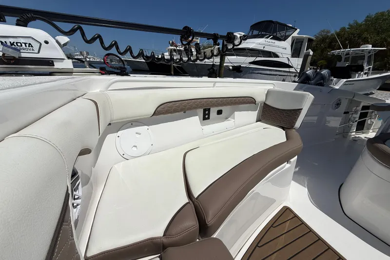 Slide: The Image of 2025 Tidewater 272 CC Adventure boat interior with cushioned seating and modern design. - 28