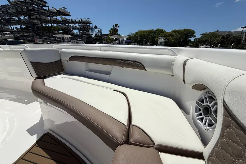 Slide: The Image of Luxurious seating on 2025 Tidewater 272 CC Adventure boat, featuring elegant upholstery and speaker system. - 29
