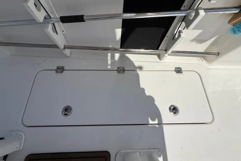 Slide: The Image of Deck hatch on 2025 Tidewater 272 CC Adventure boat, featuring stainless steel hardware. - 39