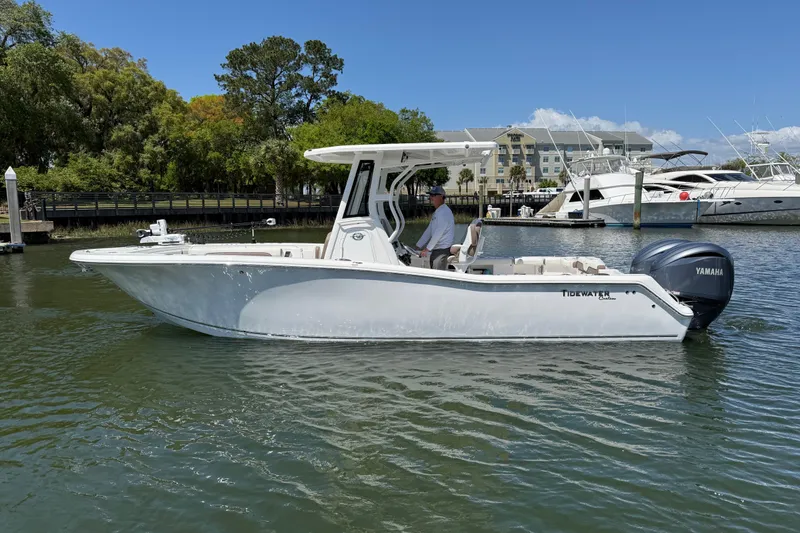 Slide: The Image of 2025 Tidewater 272 CC Adventure boat on calm water, featuring Yamaha outboard engine. - 6