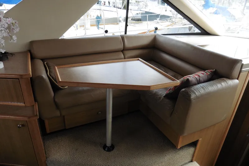 Slide: The Image of Interior of 2000 Bayliner 3988 Command Bridge Motoryacht with cozy seating and table. - 10