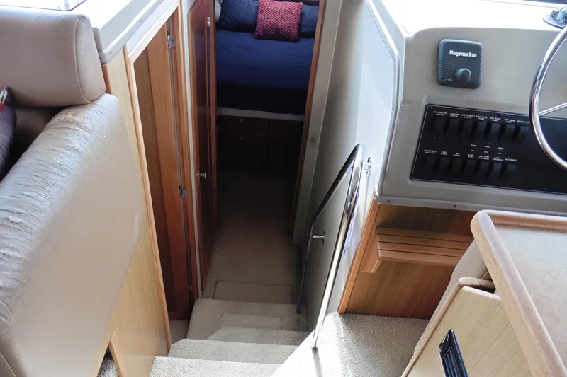 Slide: The Image of Interior view of 2000 Bayliner 3988 Command Bridge Motoryacht, featuring stairs and control panel. - 12