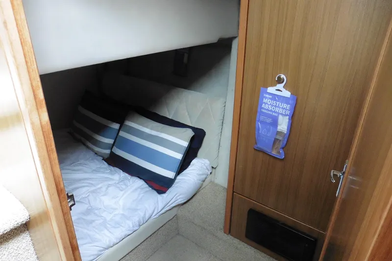 Slide: The Image of Cozy cabin interior of 2000 Bayliner 3988 Command Bridge Motoryacht with striped pillows. - 13