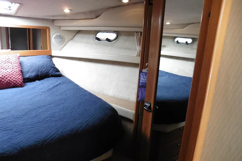 Slide: The Image of Cozy bedroom interior of 2000 Bayliner 3988 Command Bridge Motoryacht with blue bedding. - 16