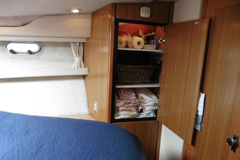 Slide: The Image of Interior of 2000 Bayliner 3988 Command Bridge Motoryacht with open storage cabinet. - 20