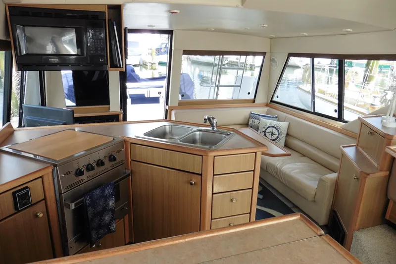 Slide: The Image of Interior of 2000 Bayliner 3988 Command Bridge Motoryacht with kitchen and seating area. - 21