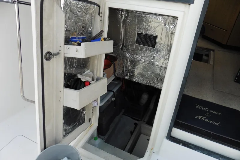 Slide: The Image of Open hatch on 2000 Bayliner 3988 Command Bridge Motoryacht with storage shelves and tools. - 22