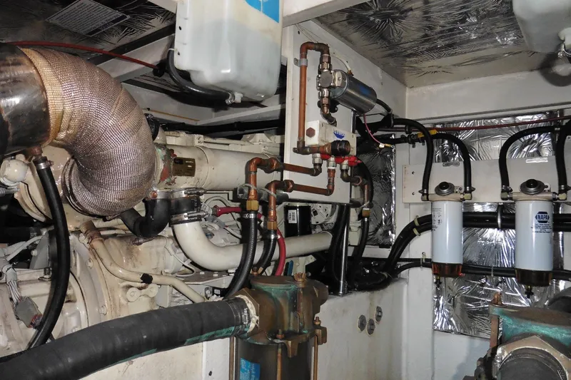Slide: The Image of Engine room of a 2000 Bayliner 3988 Command Bridge Motoryacht with visible pipes and filters. - 24
