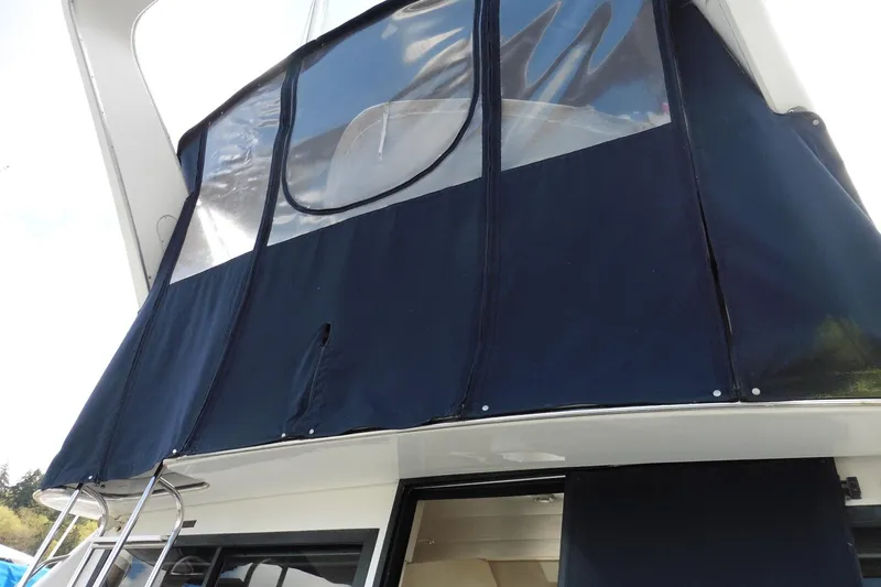 Slide: The Image of Bayliner 3988 Command Bridge Motoryacht 2000 with blue canvas enclosure. - 31