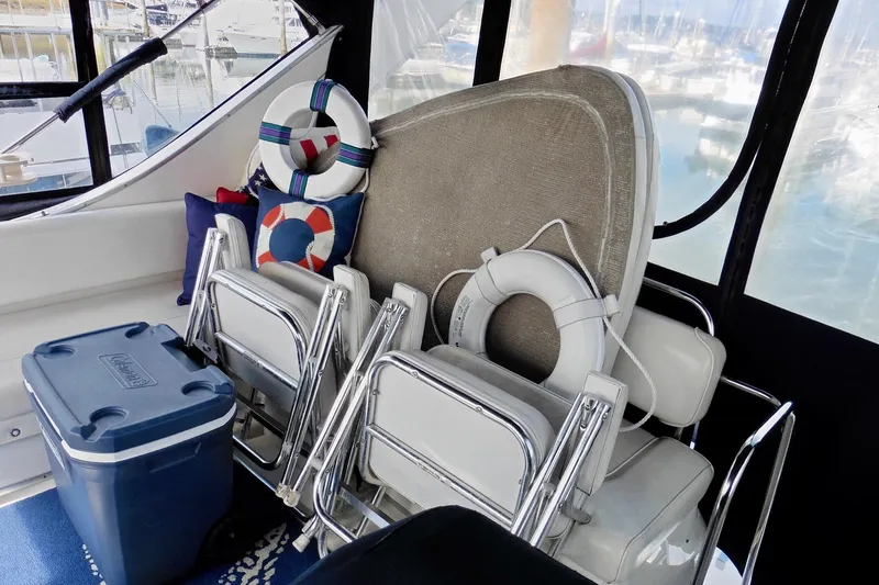 Slide: The Image of 2000 Bayliner 3988 Command Bridge Motoryacht interior with chairs, life rings, and cooler. - 34
