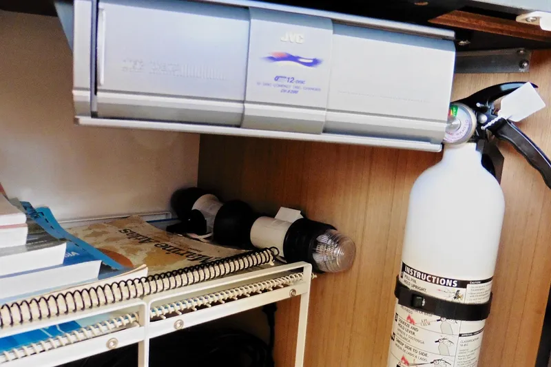 Slide: The Image of Storage area in a 2000 Bayliner 3988 yacht with fire extinguisher and JVC stereo. - 39