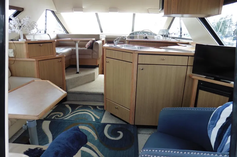 Slide: The Image of Interior of 2000 Bayliner 3988 Command Bridge Motoryacht with modern furnishings and helm. - 4
