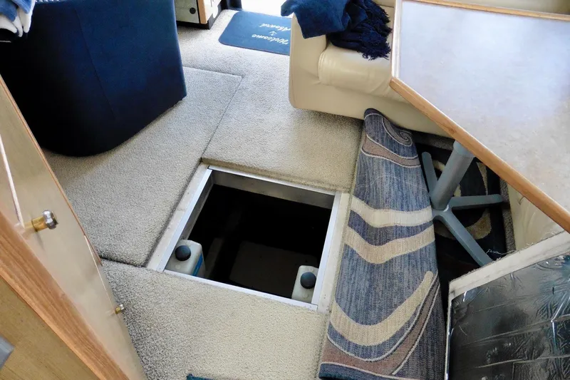 Slide: The Image of Interior of 2000 Bayliner 3988 yacht showing open floor hatch and seating area. - 41