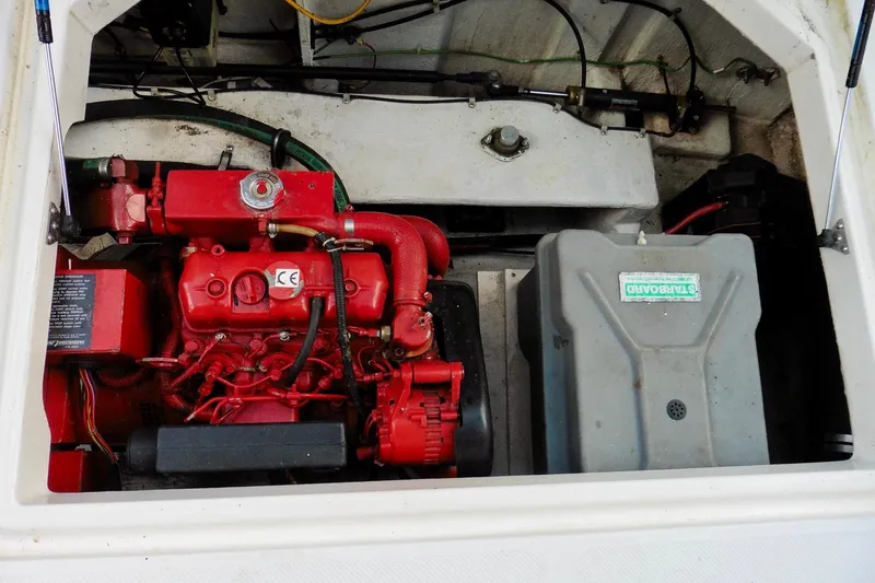 Slide: The Image of Engine compartment of 2000 Bayliner 3988 Command Bridge Motoryacht, featuring red engine and components. - 44