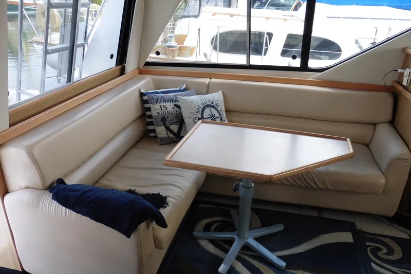 Slide: The Image of Interior of 2000 Bayliner 3988 Command Bridge Motoryacht with cozy seating and nautical decor. - 5