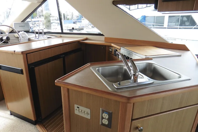 Slide: The Image of Interior of 2000 Bayliner 3988 Command Bridge Motoryacht kitchen with sink and appliances. - 7