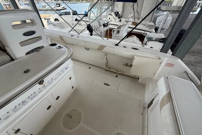 Slide: The Image of 2004 Boston Whaler 320 Outrage boat interior with seating and storage compartments. - 15