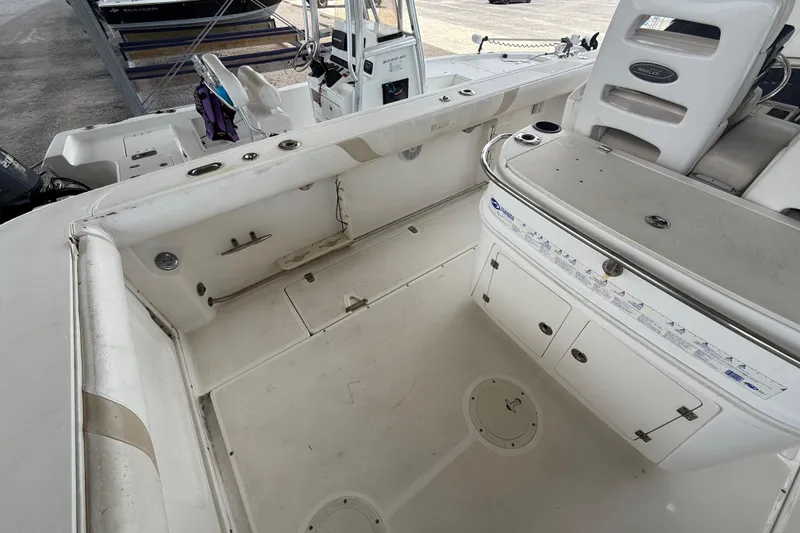 Slide: The Image of 2004 Boston Whaler 320 Outrage boat interior, featuring spacious deck and storage compartments. - 16