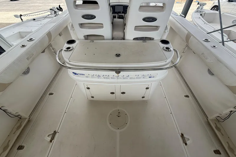 Slide: The Image of 2004 Boston Whaler 320 Outrage boat interior with seating and storage compartments. - 17