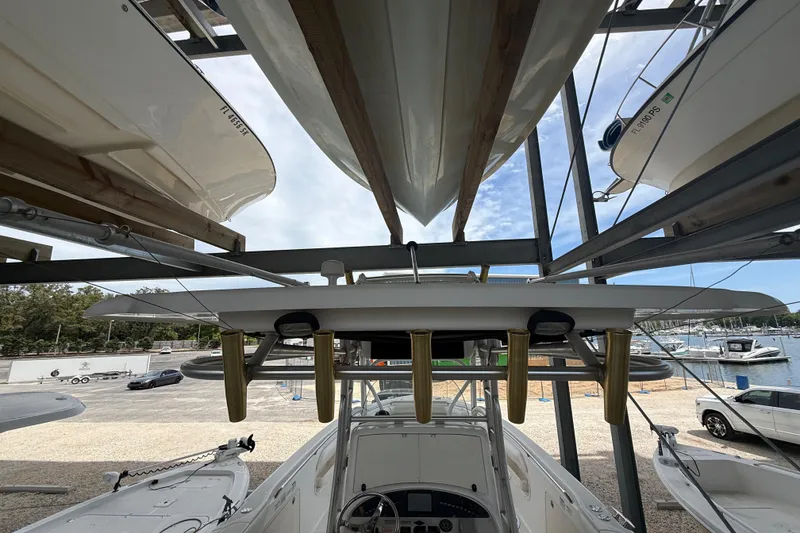 Slide: The Image of 2004 Boston Whaler 320 Outrage boat stored on a rack at a marina. - 18