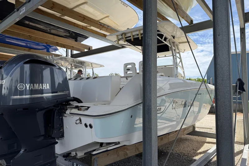 Slide: The Image of 2004 Boston Whaler 320 Outrage boat with Yamaha engine in storage rack. - 2