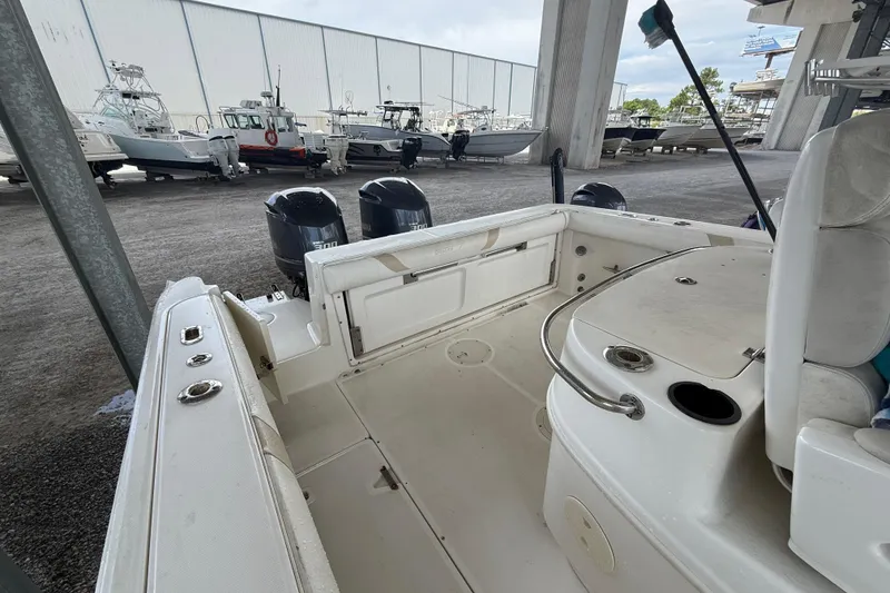 Slide: The Image of 2004 Boston Whaler 320 Outrage boat interior with dual engines, docked in a marina. - 21