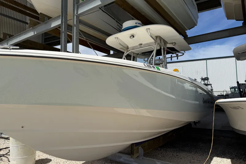Slide: The Image of 2004 Boston Whaler 320 Outrage boat in storage, showcasing sleek design and sturdy build. - 23