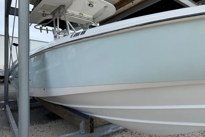 Slide: The Image of 2004 Boston Whaler 320 Outrage boat on a storage rack, side view. - 3