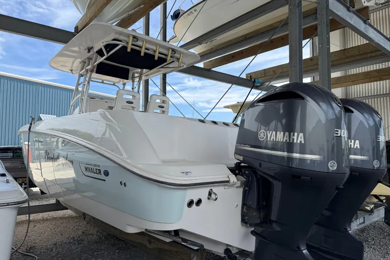 Slide: The Image of 2004 Boston Whaler 320 Outrage with twin Yamaha engines in storage facility. - 5